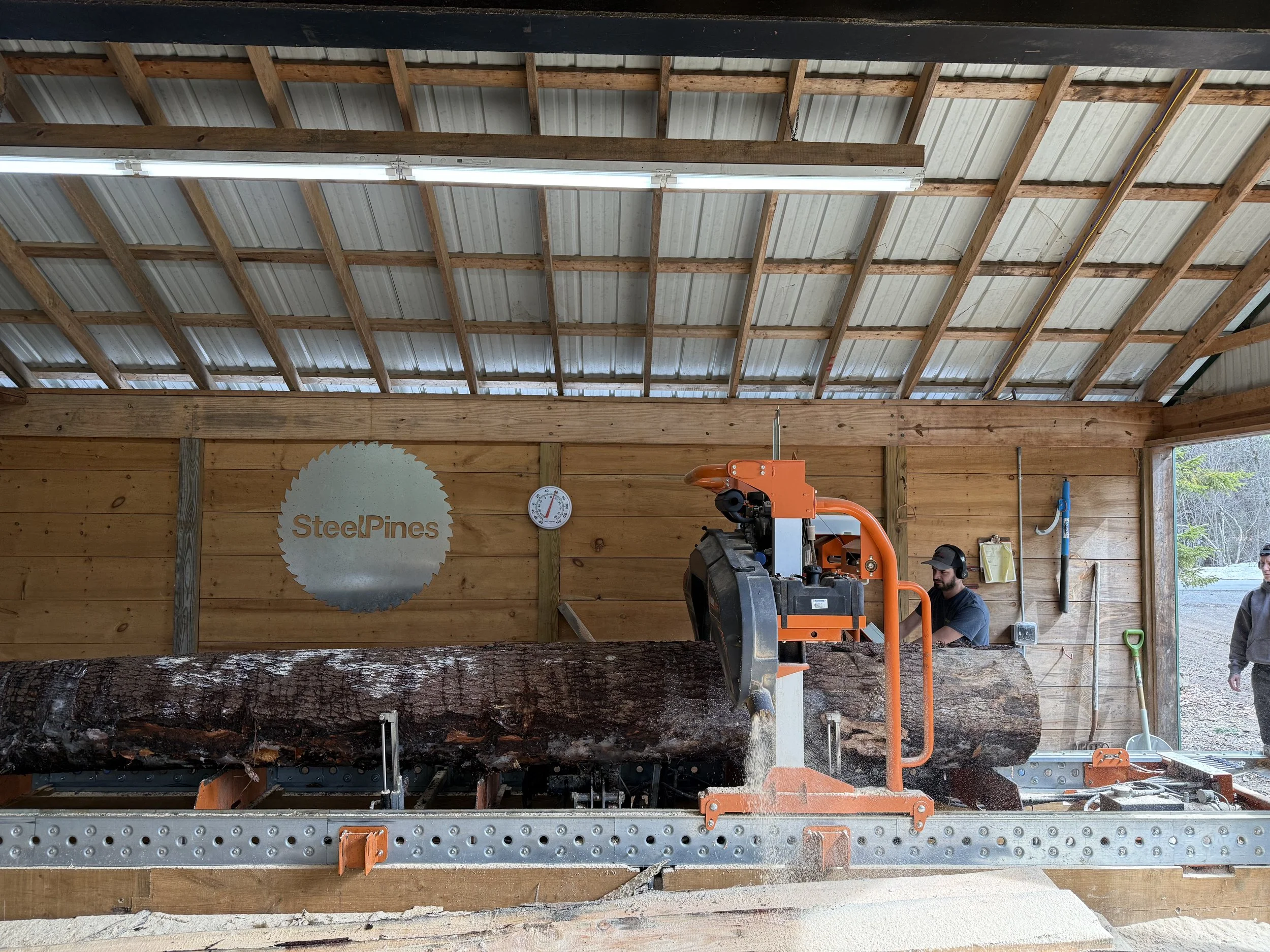 Milling lumber on the Norwood Sawmill at Steel Pines shop.