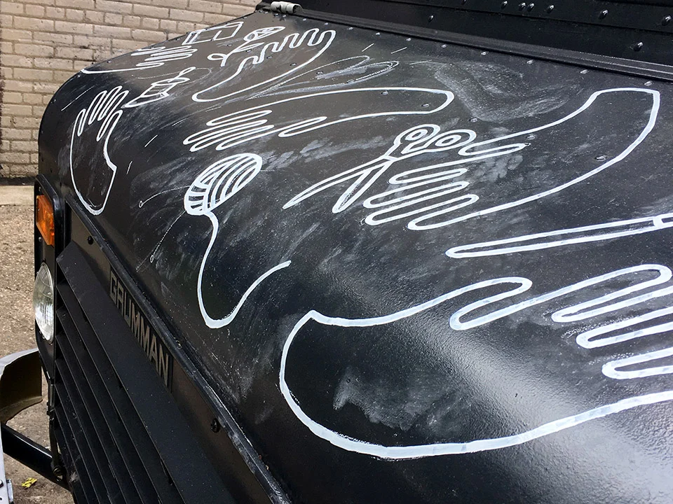 Painting the white lines on the hood of the truck