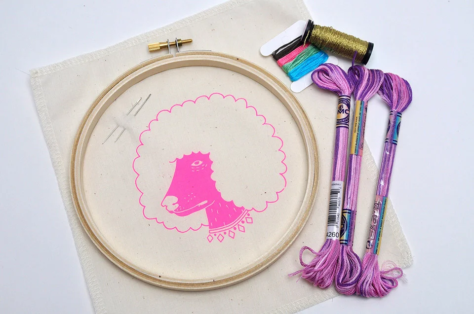 A Standard kit includes all of the above: printed fabric, embroidery hoop, all necessary floss, two needles, and a felt piece for the backing