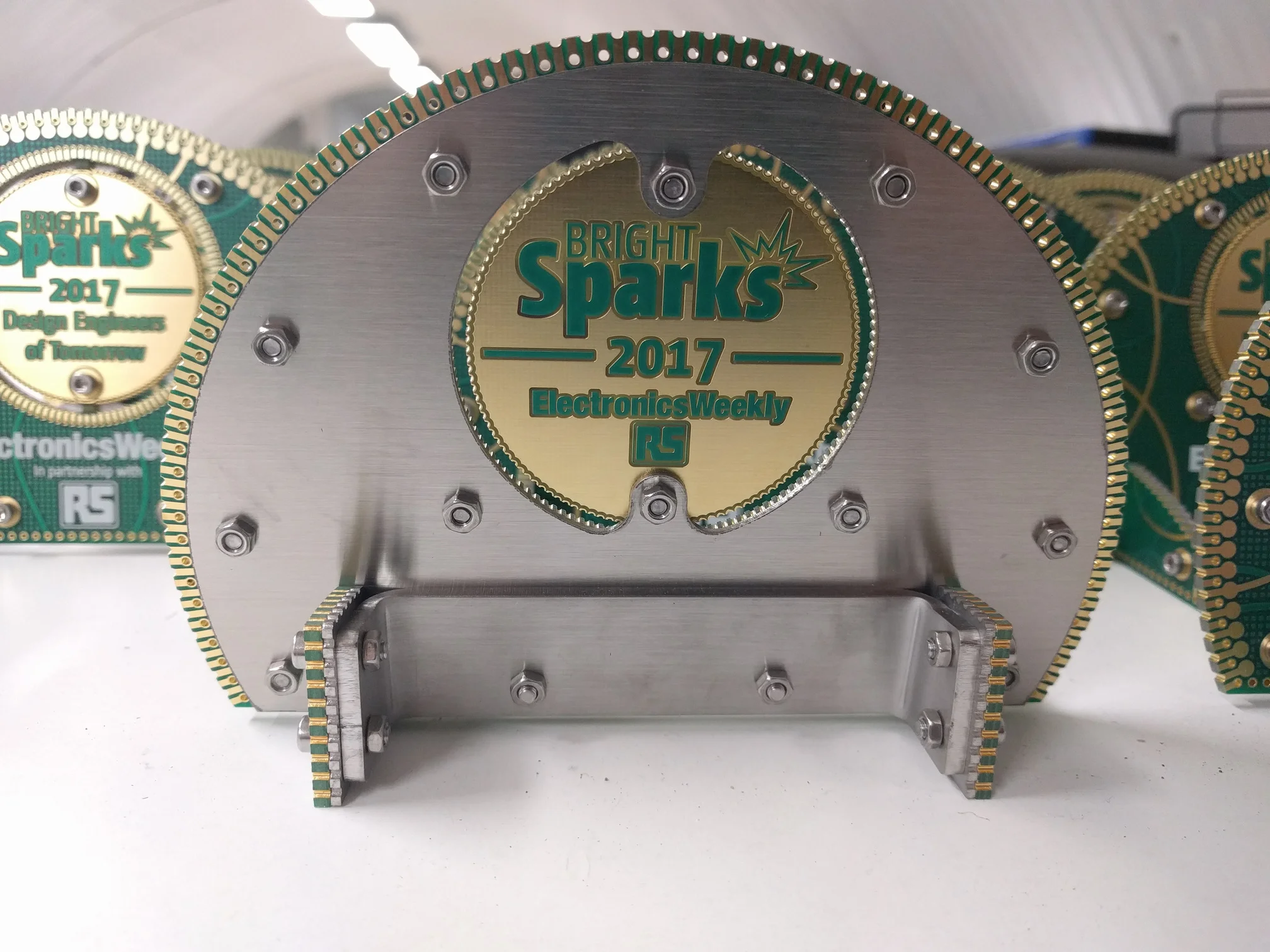 The back of the trophy. The main body and stands have a 1.5mm thick stainless steel backing attached with M3 screws and nuts. A custom 3mm thick stainless bracket holds everything together and adds weight. The position of the bracket also lowers the centre of gravity so that the piece sits solidly on the surface.