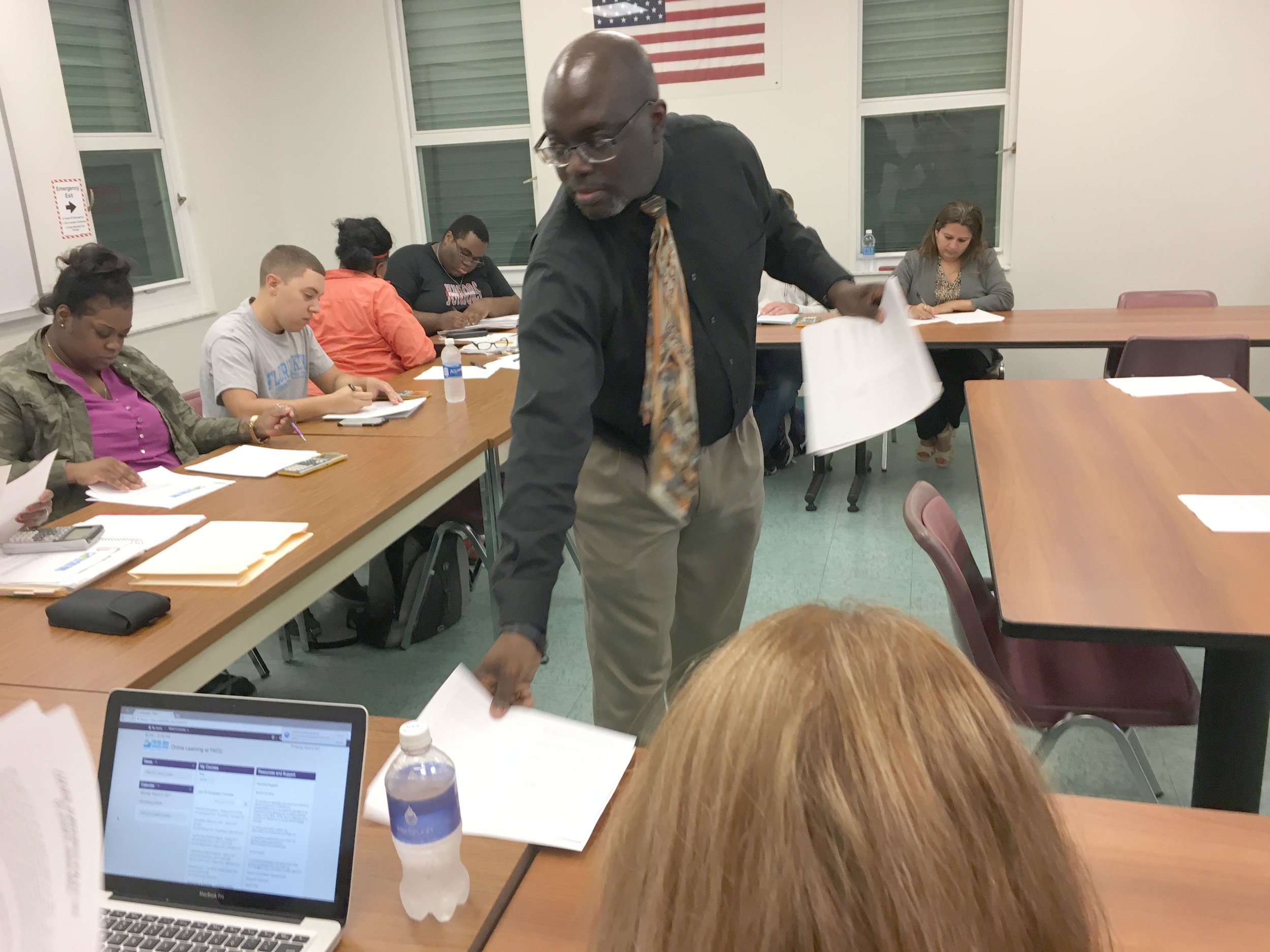 Professor Jemal Alston — better known as Dr. J — hands out a syllabus to a financial management class at Florida Keys Community College. Photo by Nancy Klingener