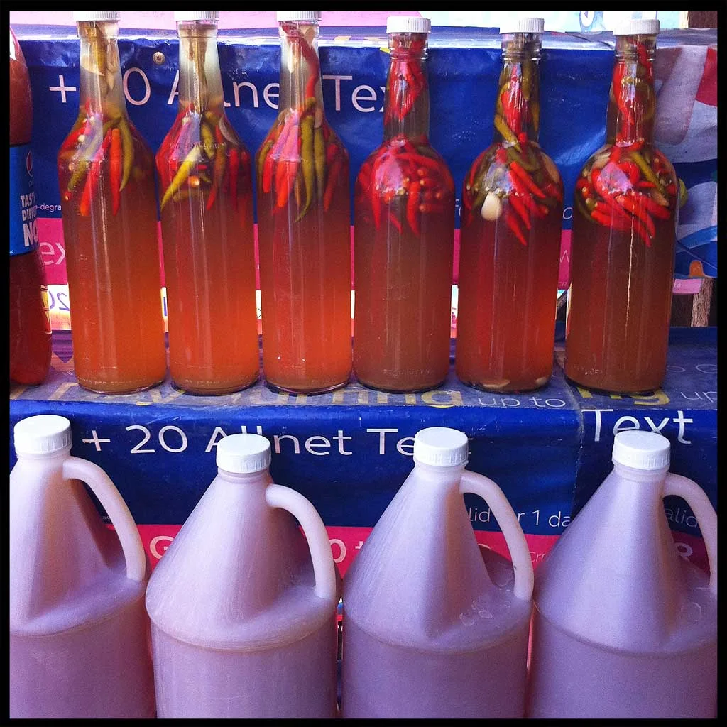 Bottles and jugs of different types of vinegar are found along the highway in Binalonan, Pangasinan. 