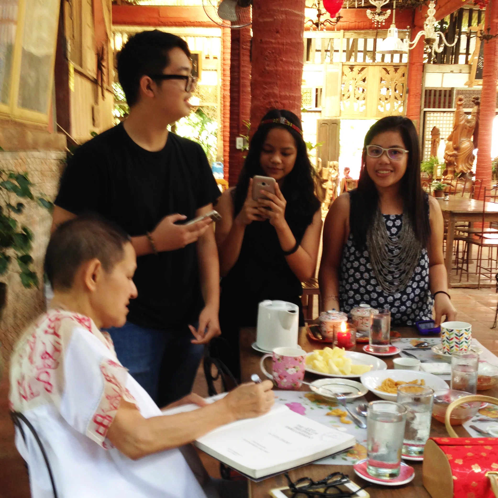 Book signing. Patis signs her book 'The Art of Philippine Embellishment' brought by students from Philippine High School for the Arts. 