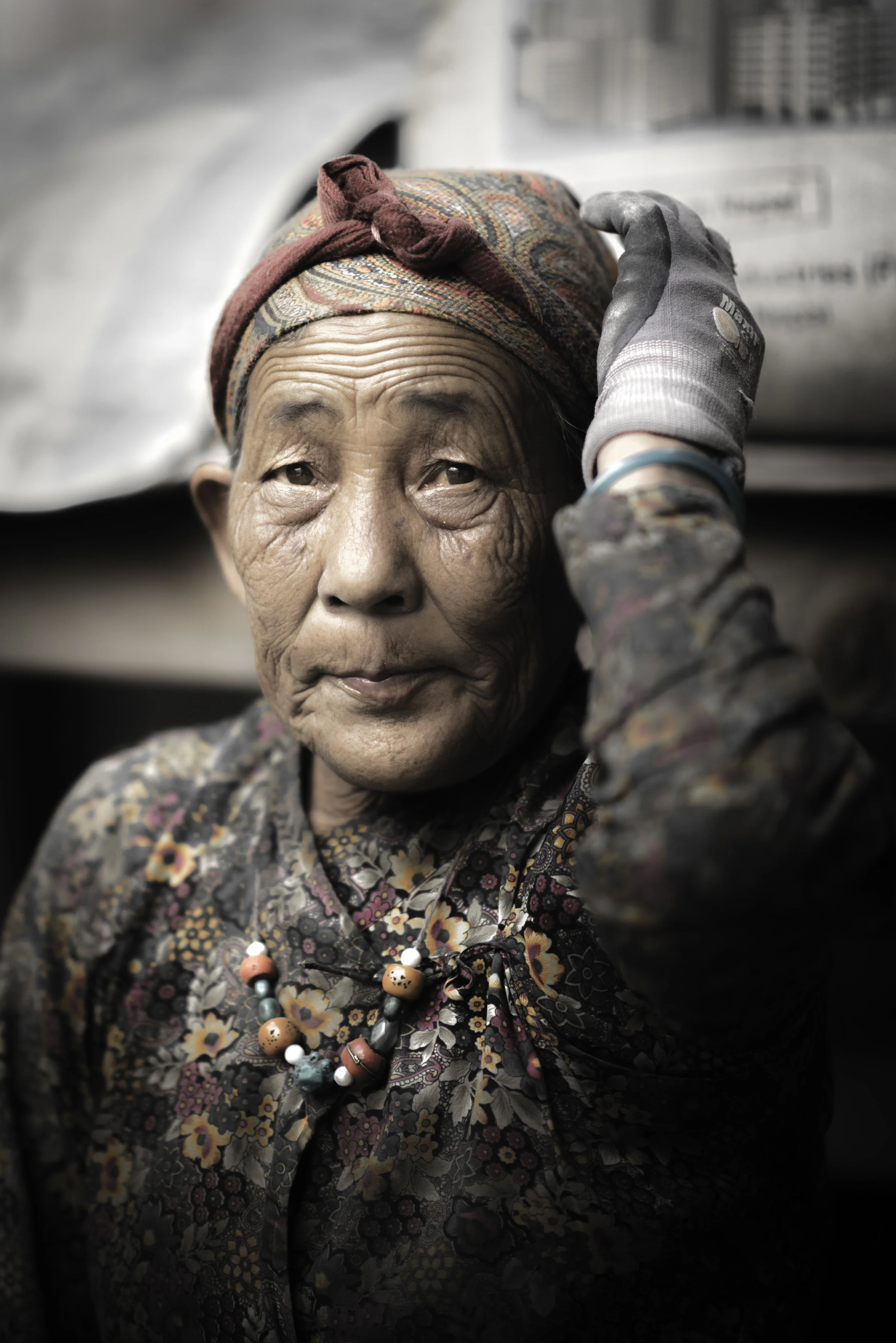   Nyima Lama breaks stones into smaller pieces for the construction of a new path in the damaged village. All day she works to rebuild the town.  