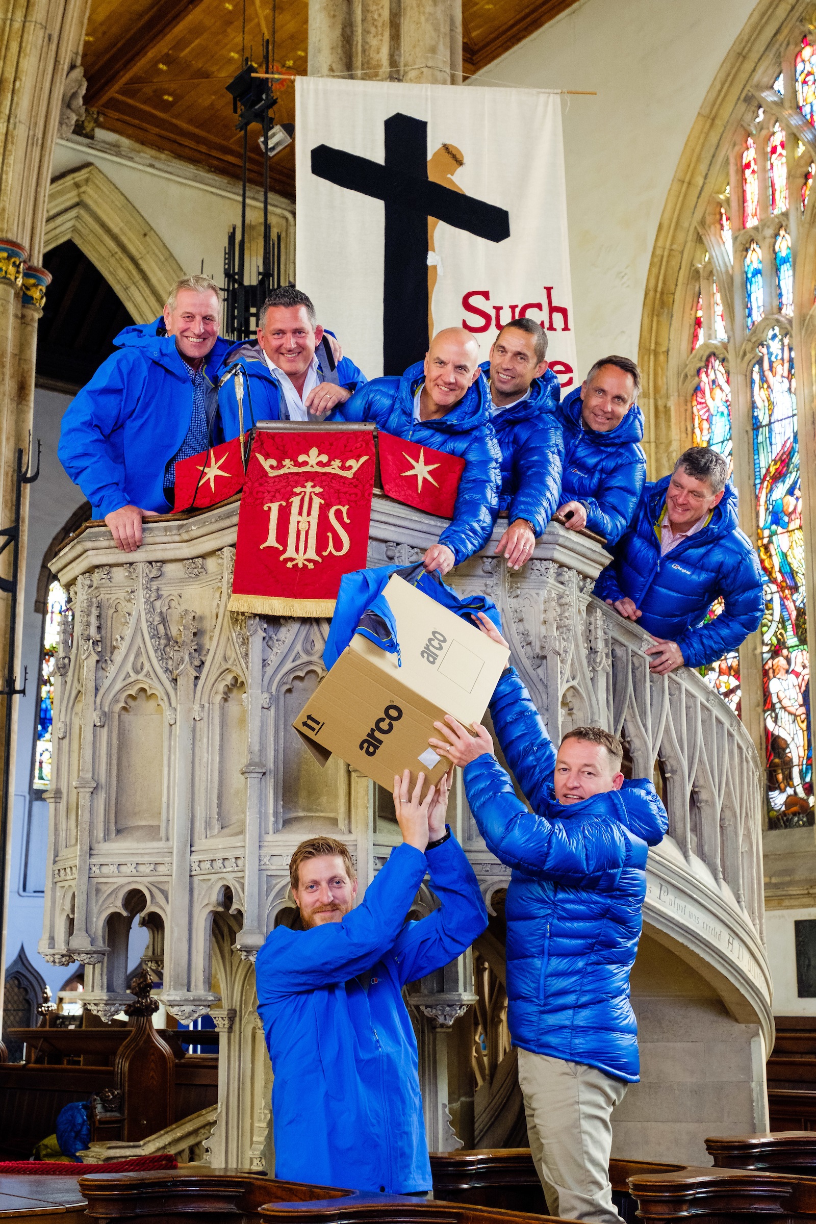 Andy Parkinson (Spencer Group), bottom left, and Neil Riseham (Arco) pass the donated clothing to Kilimanjaro team members, from left, Andy Allenby (Allenby Commercial), Nic Marshall (ResQ Outsource Solutions), Jonathan Leafe (Strawberry), Dave Garness (Garness Jones), Nick Ward (Alan Wood and Partners) and Brian Gilliland (Holy Trinity) in the pulpit at historic Holy Trinity Church