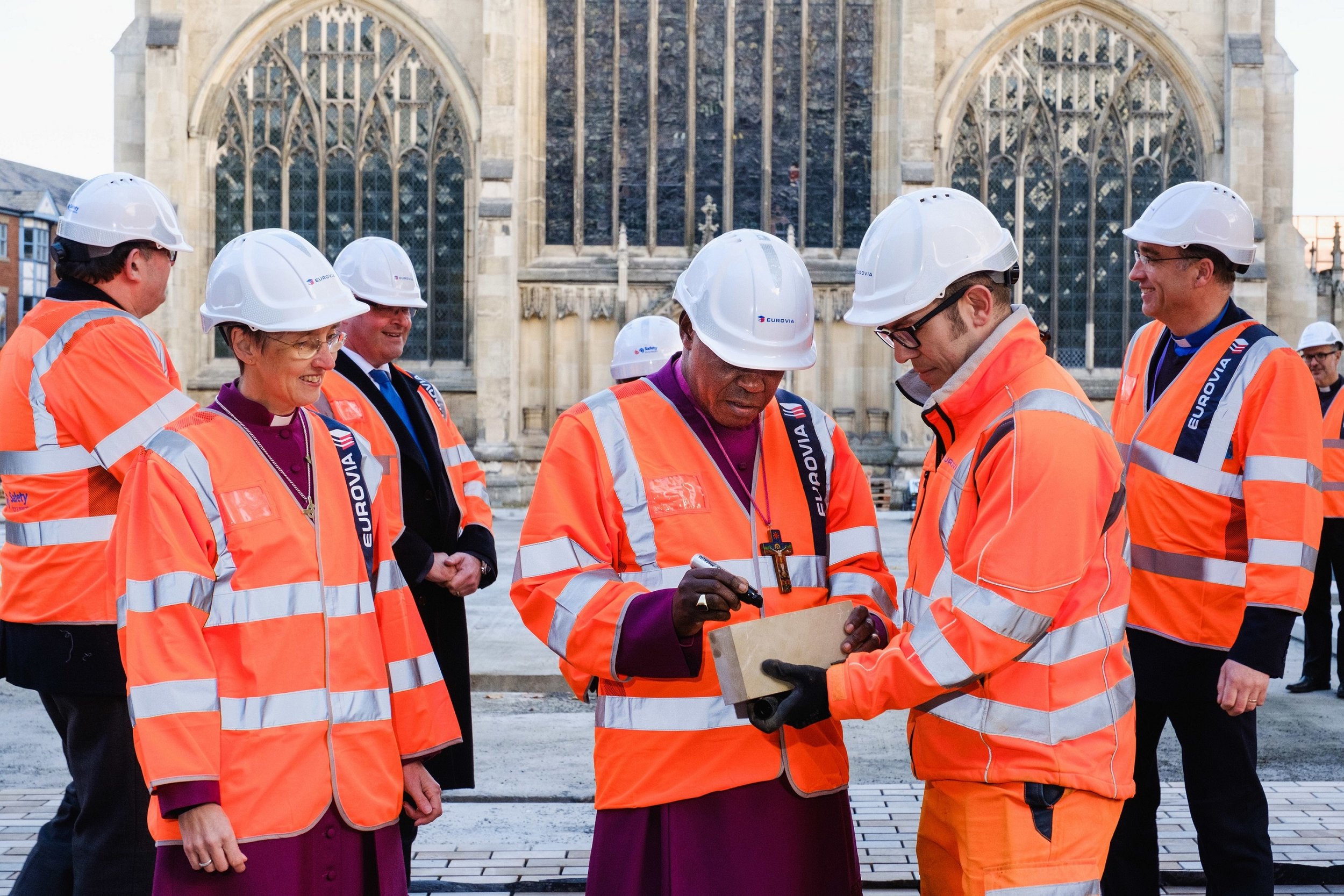 The Archbishop signs a paving stone in the presence of the Bishop of Hull, the Right Reverend Alison White, and Tim Croft, Site Manager for the Trinity Square works being delivered by contractors Eurovia Contracting.