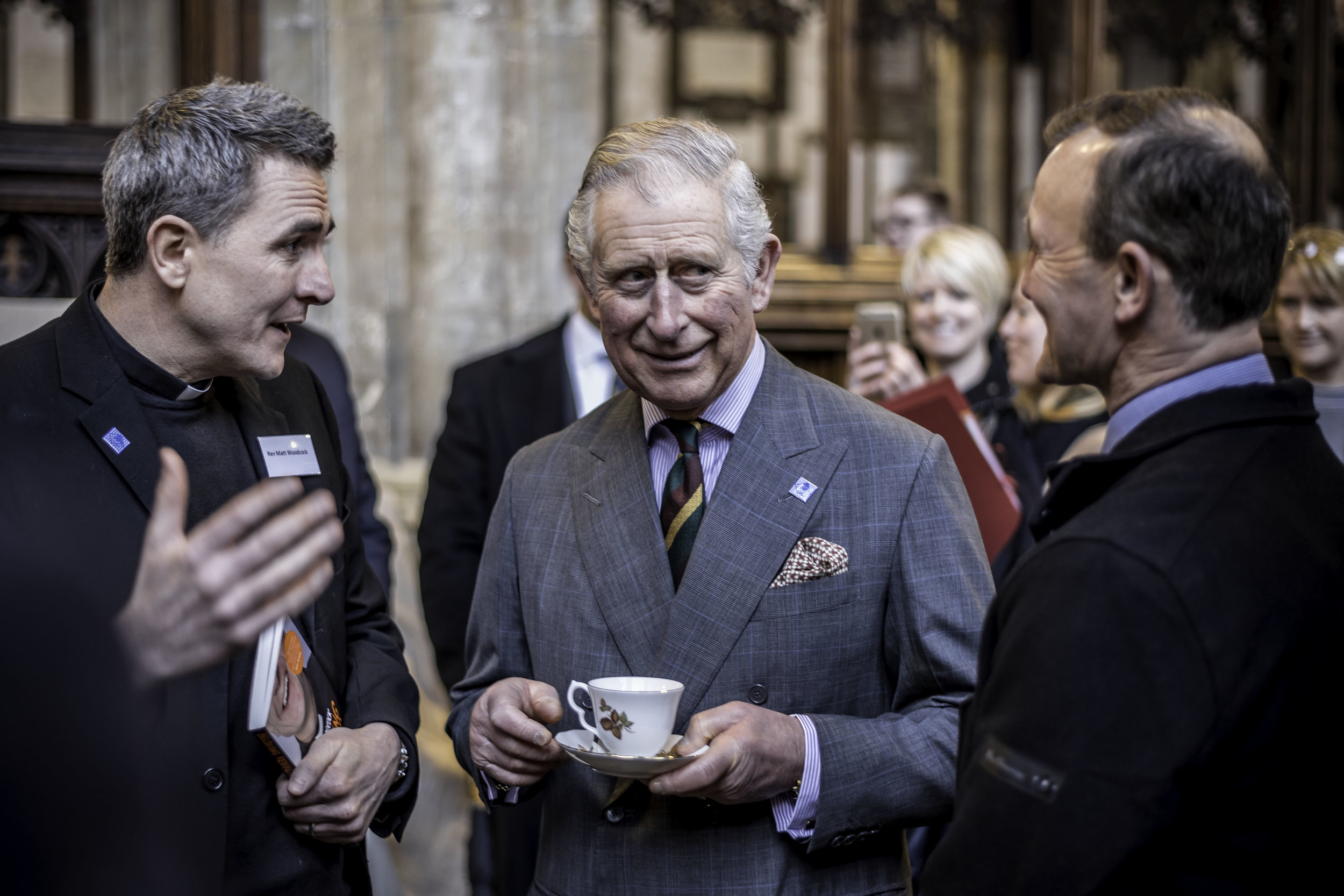 The Prince of Wales shares a joke with Holy Trinity Pioneer Minister Rev Matt Woodcock and St Paul’s Boxing Club Coach Mick Bromby.