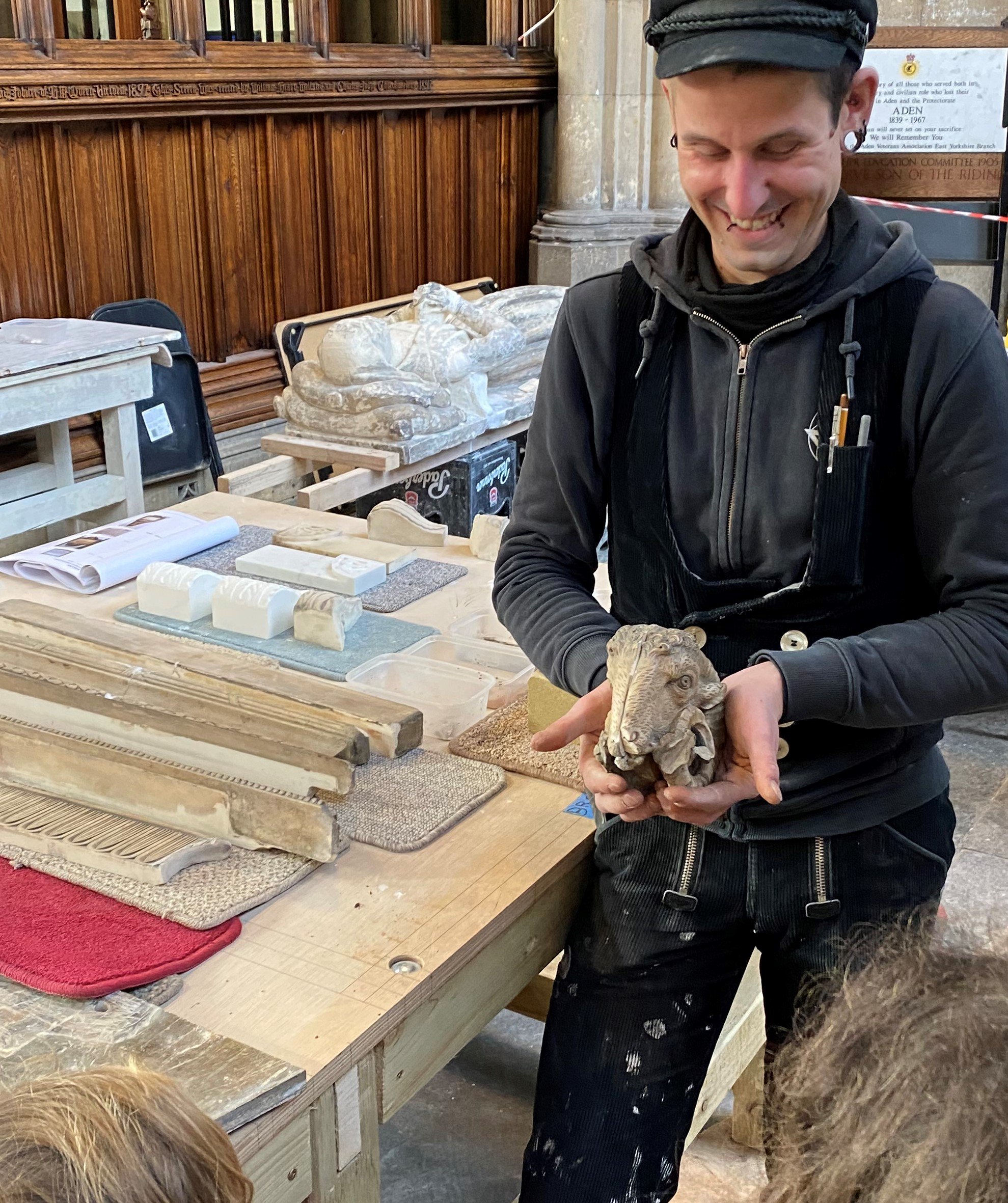 Stonemason with rams head in workshop.jpg