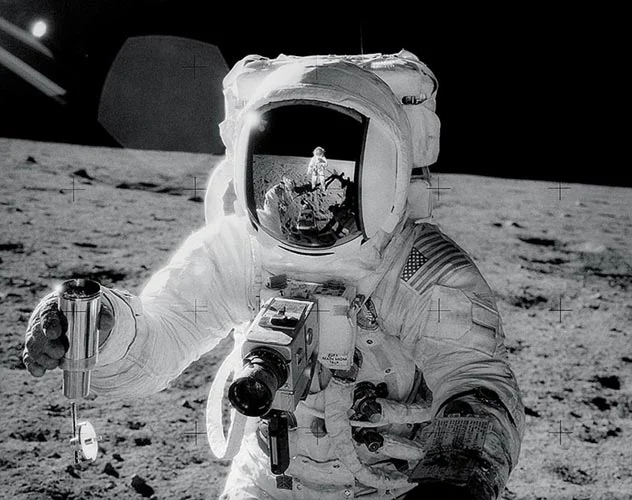 Buzz Aldrin shot by Neil Armstrong (who you can also see in the helmet reflection). Buzz is holding his Hasselblad and Neil is using one to take the photo