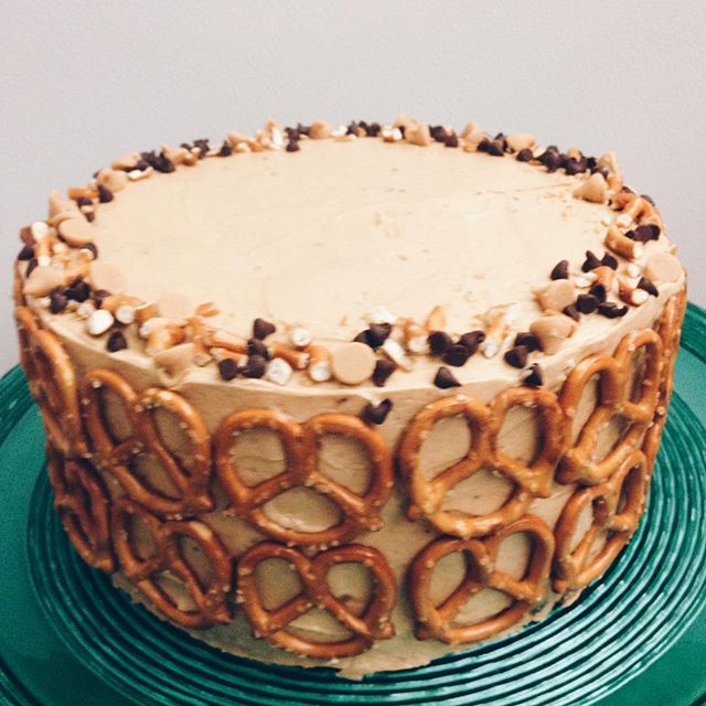 Layered chocolate cake, peanut butter frosting, salty pretzels and pb chocolate chips on top. 🍰