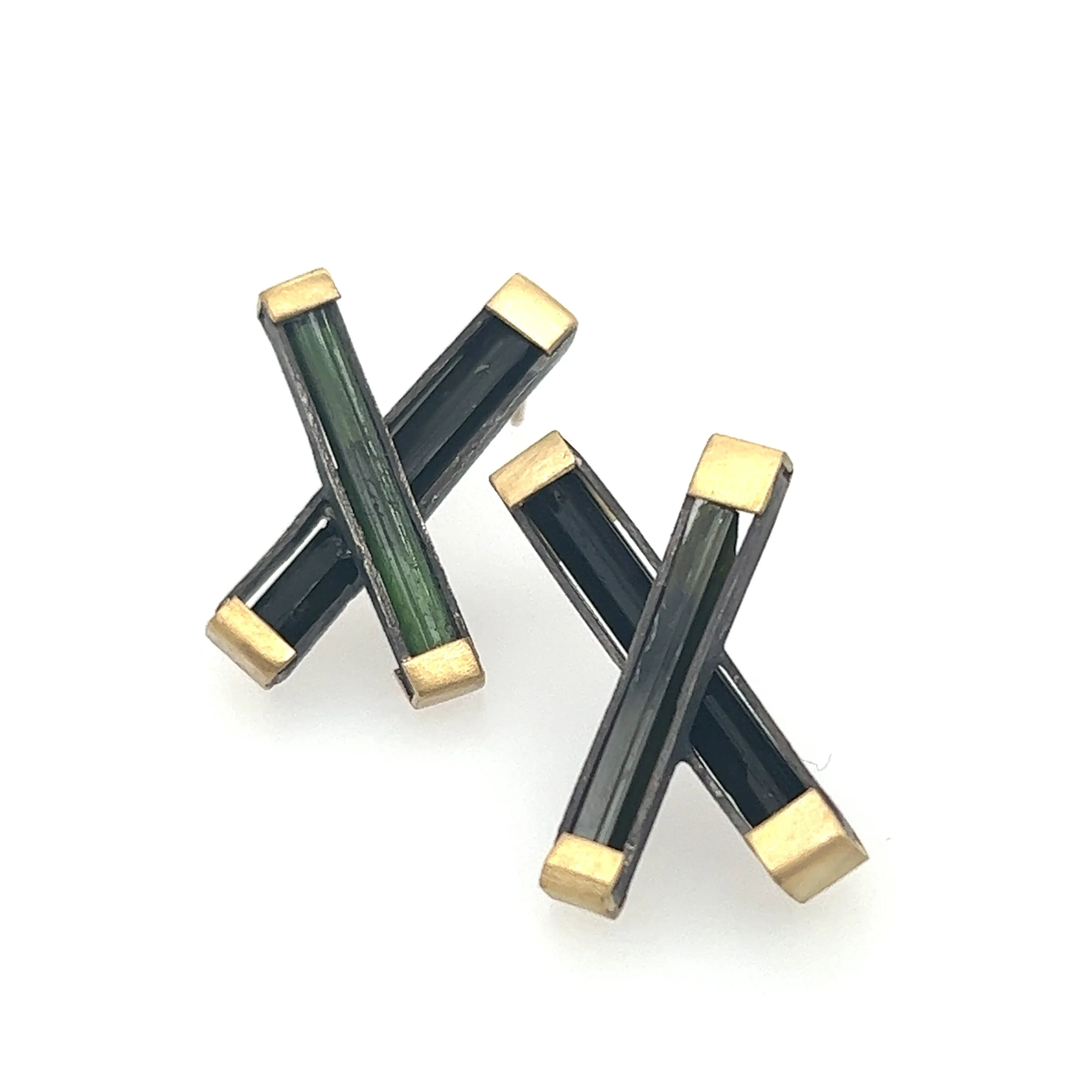 Dark green stones surrounded by black and gold metal