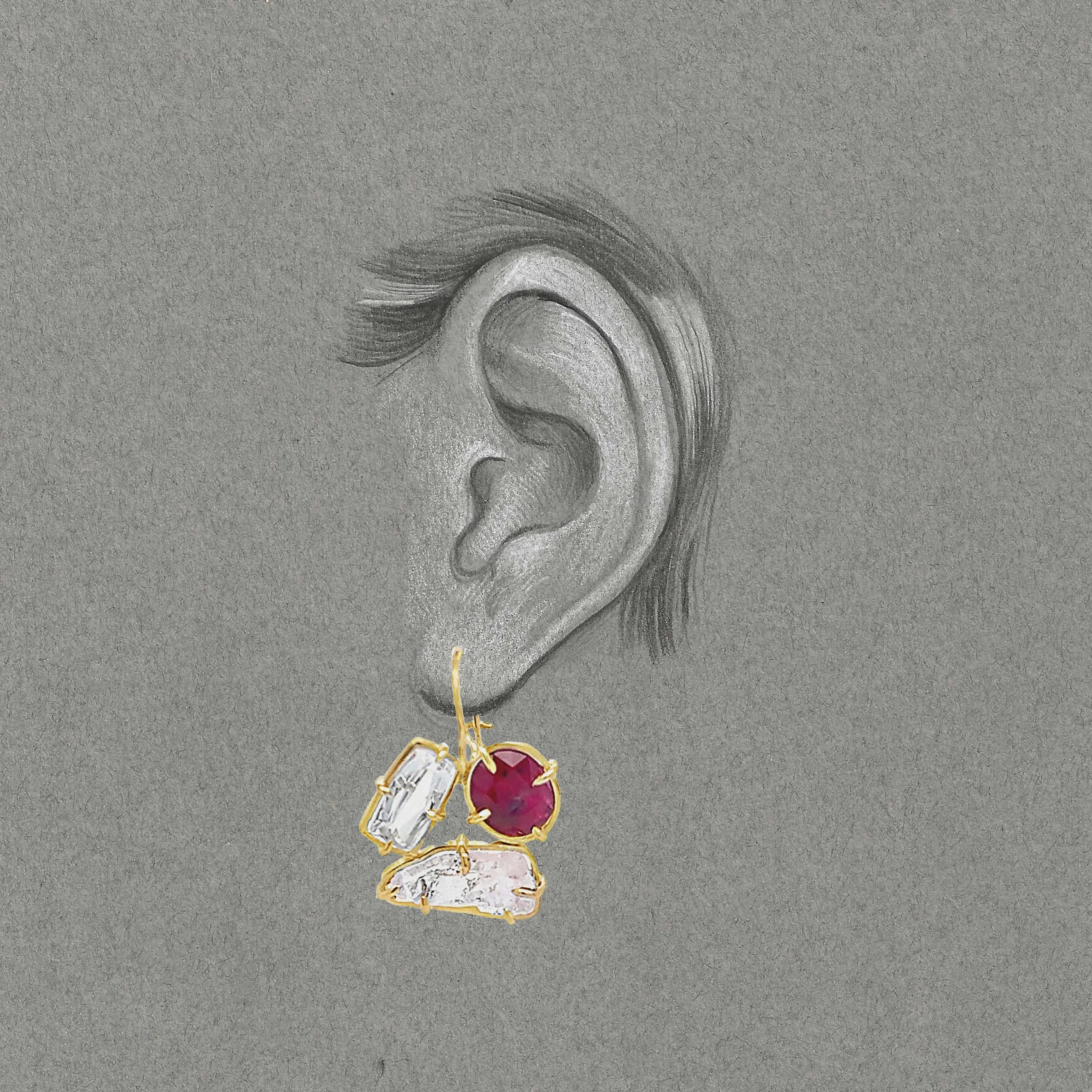 a grey drawing of an ear with a pink and red earring superimposed on it