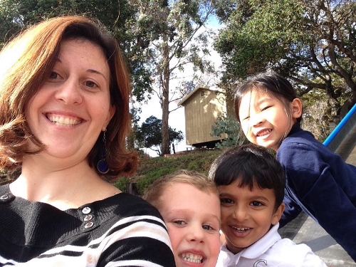 Miss Marquardt and some kindergartners being silly at recess.