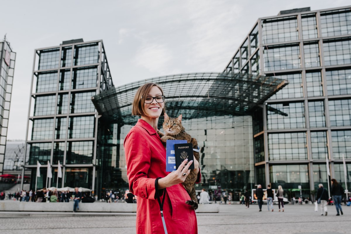Outside Berlin Hauptbahnhof (central train station). My passport, and Aífe's. Yes, vets in the EU can issue pet passports. Read all about planes, trains, and the bureaucracy of pet travel in my little book. Photo by Juliana Socher.