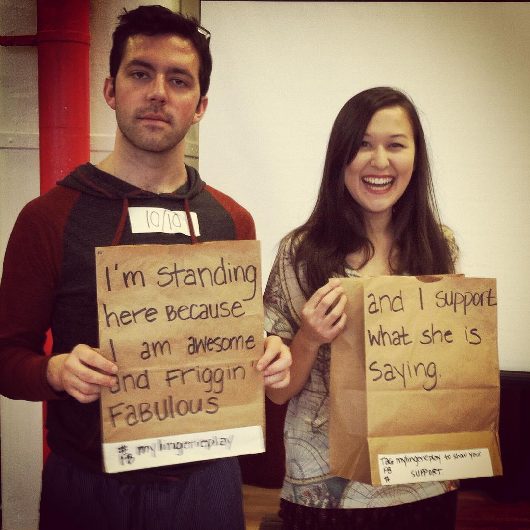 Robert and Emily holding messages of support.