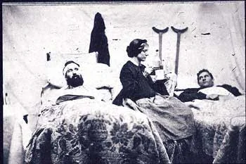 Civil War nurse attending to wounded soldiers.