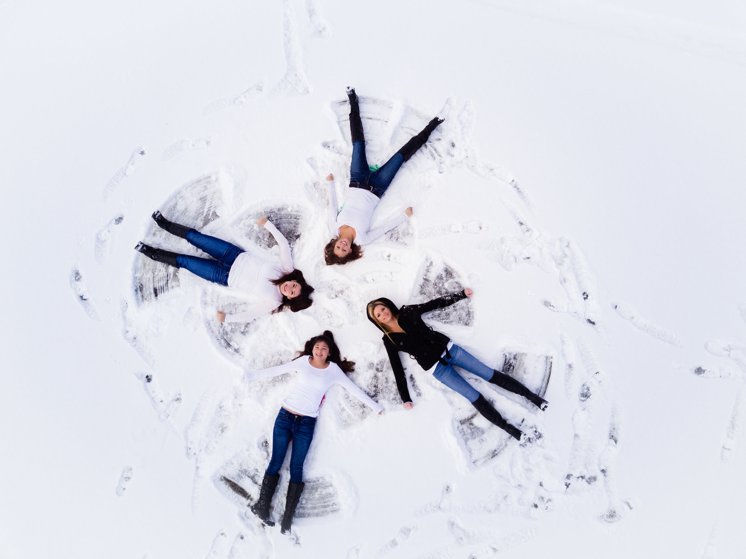 Mother and Daughters Making Snow Angels
