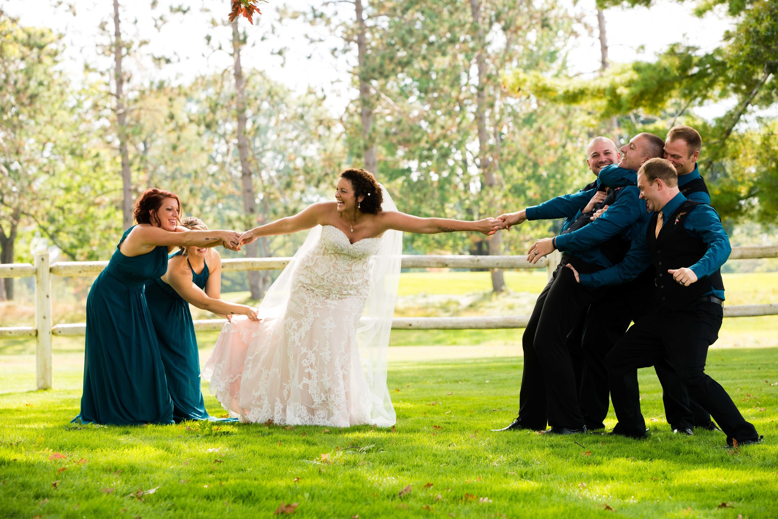 Bride Being Pulled By Husband and Her Friends
