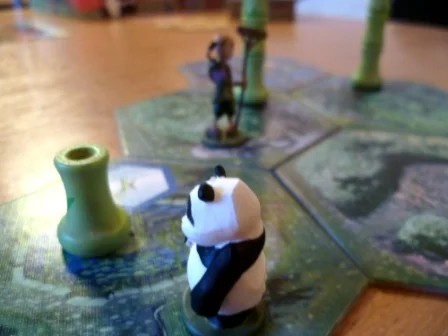 The Panda examines new bamboo growth whilst the Gardener looks on