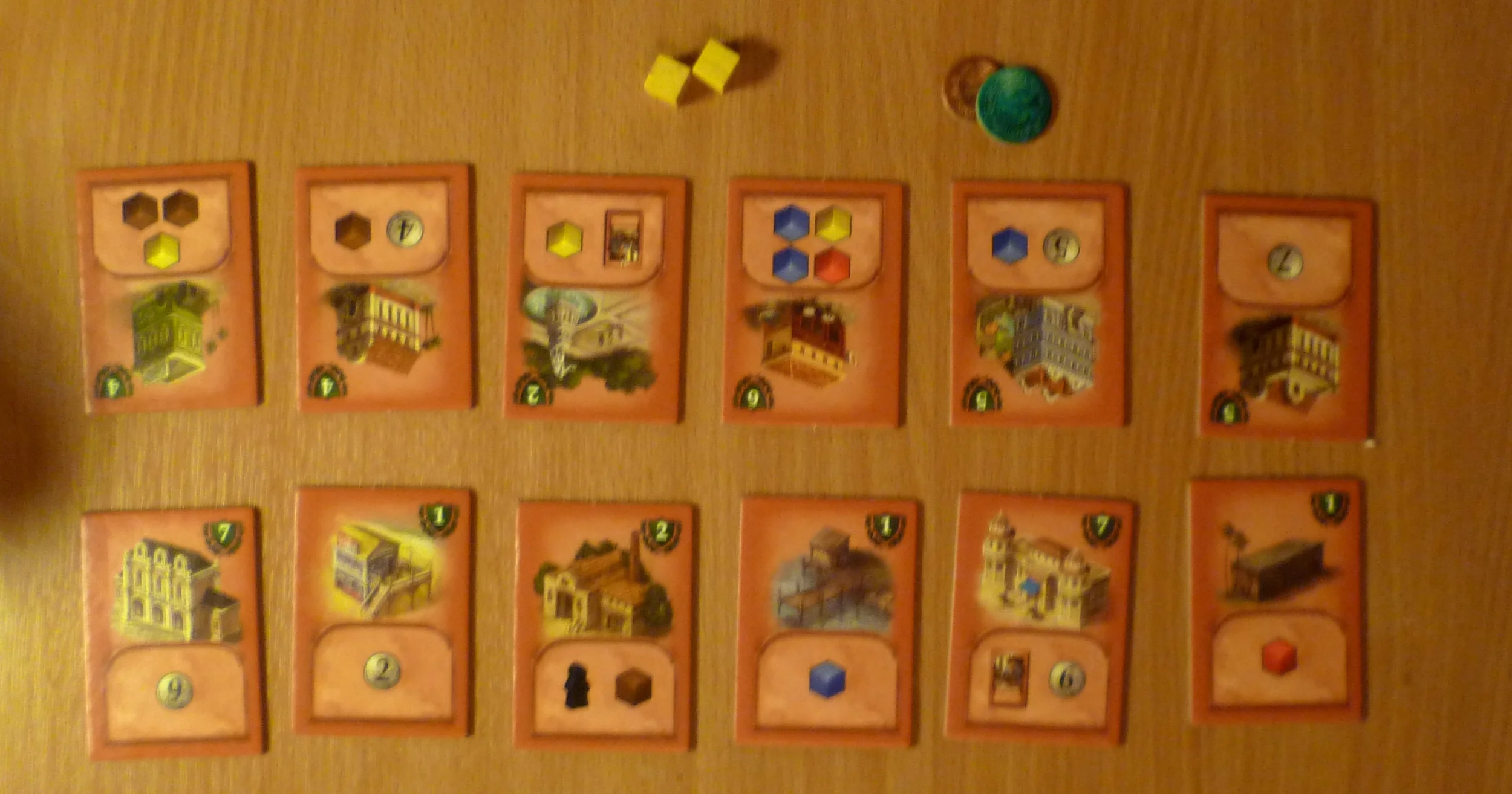 Victory point tiles with turns supply of cubes and money at the top