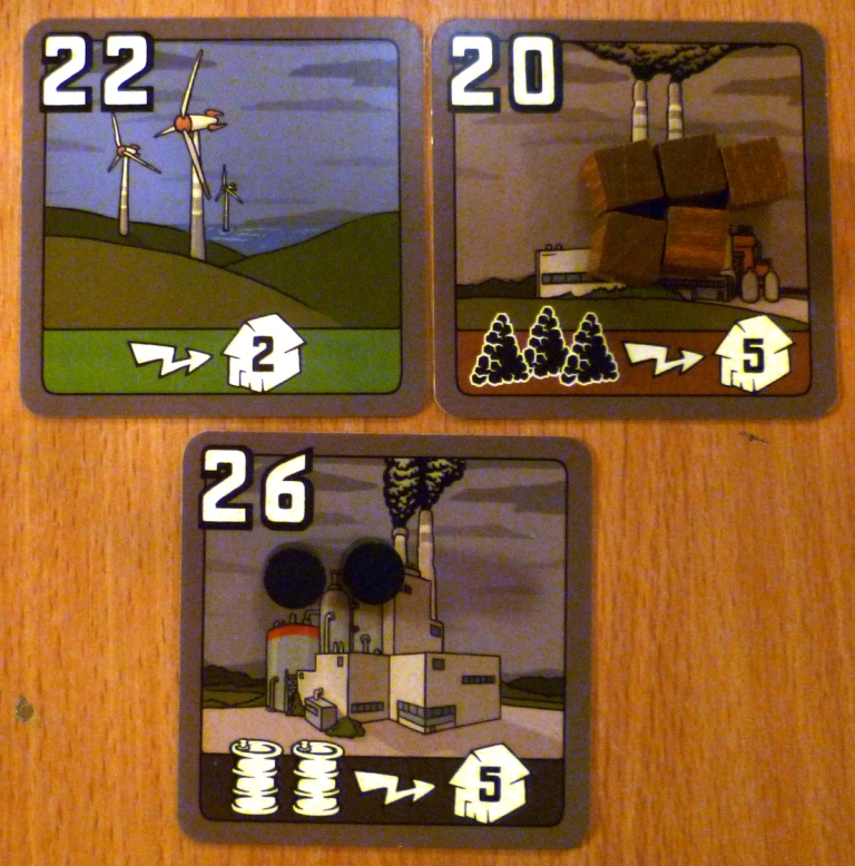 Three different factories using a total of 3 Coal and 2 Oil to provide energy to 12 Cities. The Green Power Station requires no resources.