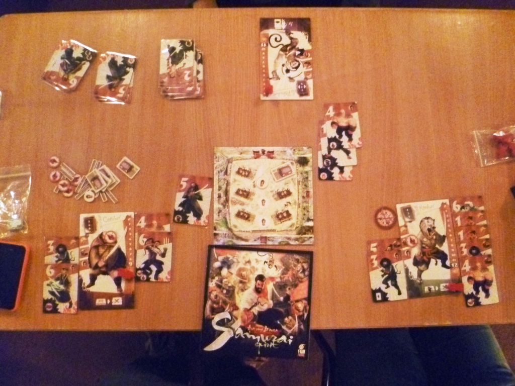 Samurai showing player hands and village board down to the last hut. Photo by our guest photographer "J"