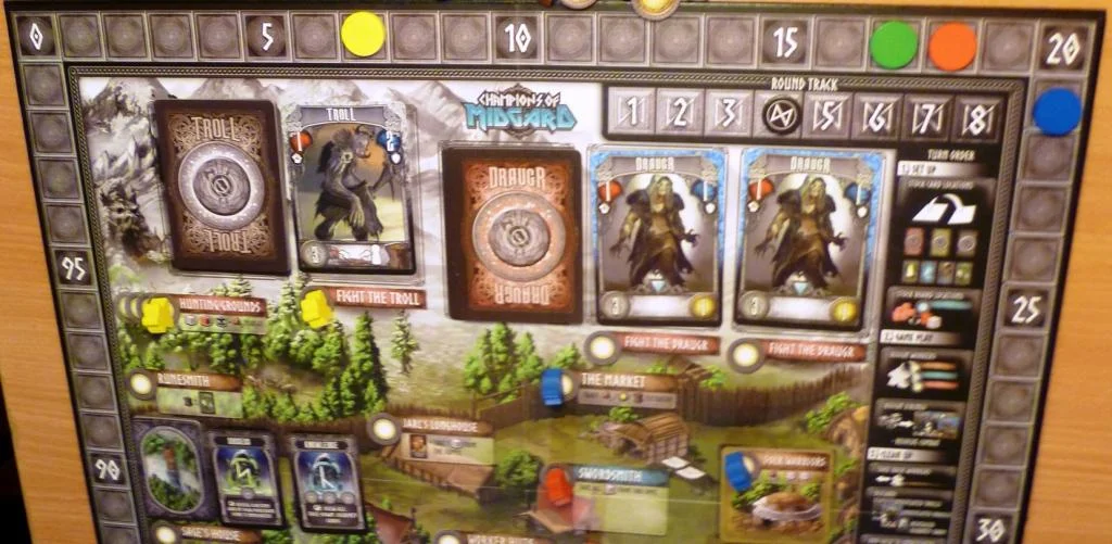 Top end of the board with the weaker combats, some meeples are shown on worker spaces