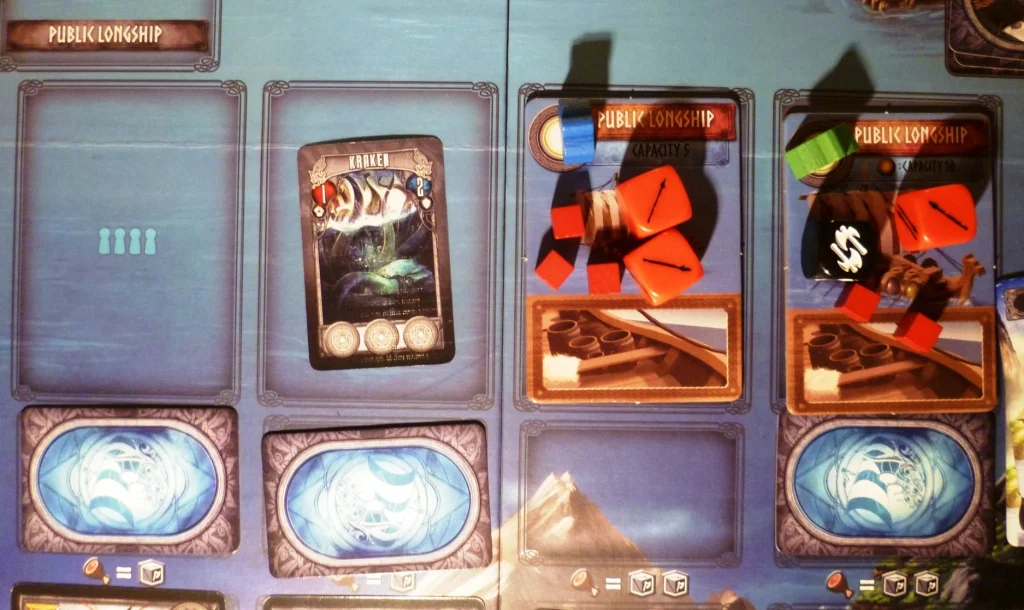 The combat dice are on a boat together with food, the small blue cards are events to overcome before combatting opponents at the bottom edge of the board.