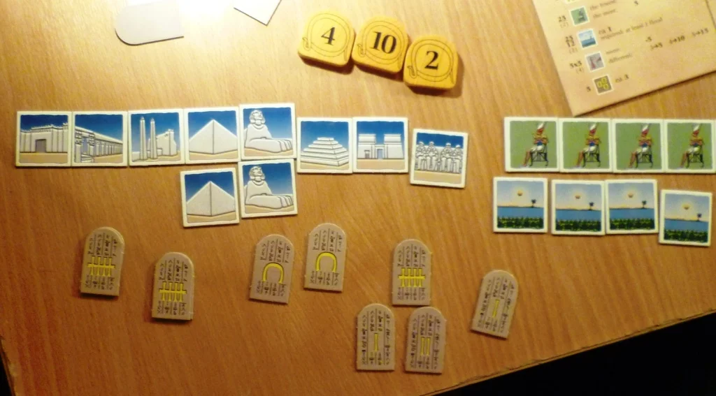 This player has bidding tiles 2, 4 and 10 and has collected quite a few monument tiles for scoring at the end of the game.