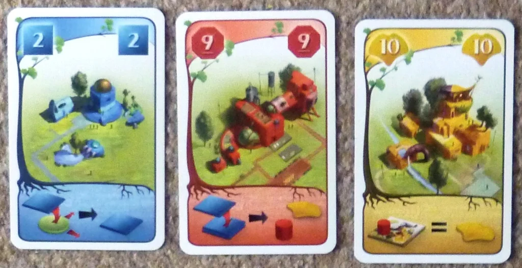A sample of the cards, the bottom section of a card shows the bonus for that type of action, the right hand card is showing a game end bonus.