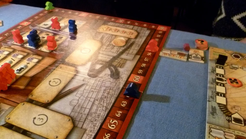 Some of the worker placement spaces on the main board and the score markers around the edge. A player board is to the right
