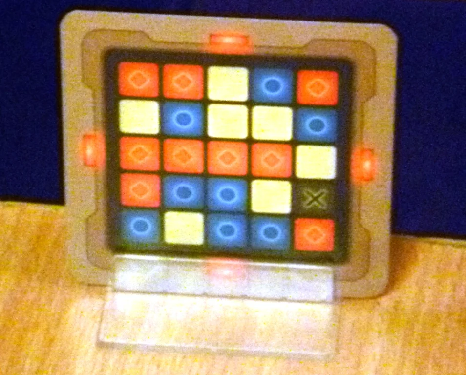 Codenames grid card showing locations of red and blue spies and the assassin "X"