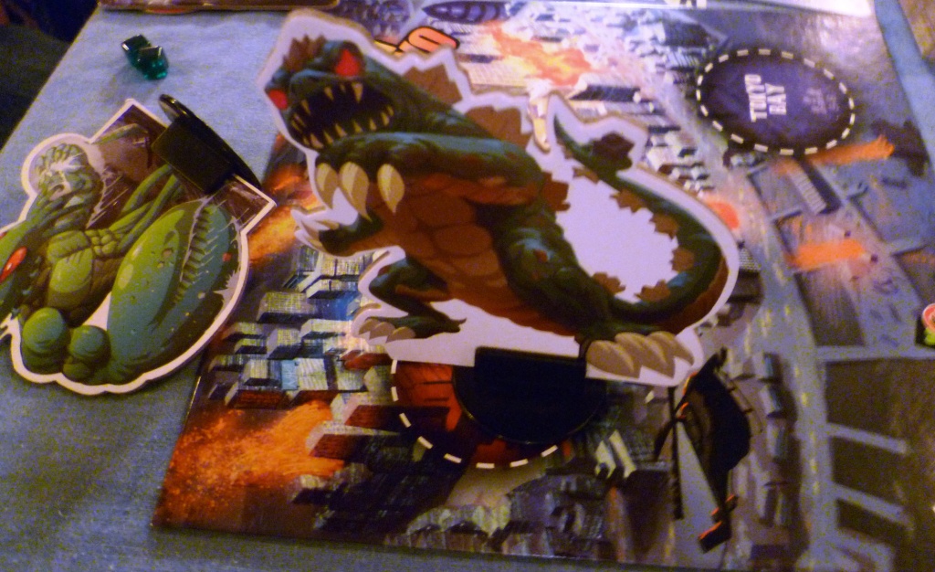 A monster in Tokyo looming over one of the K.O.'d pieces, if you survive in Tokyo for a whole round you get 2 VP's.