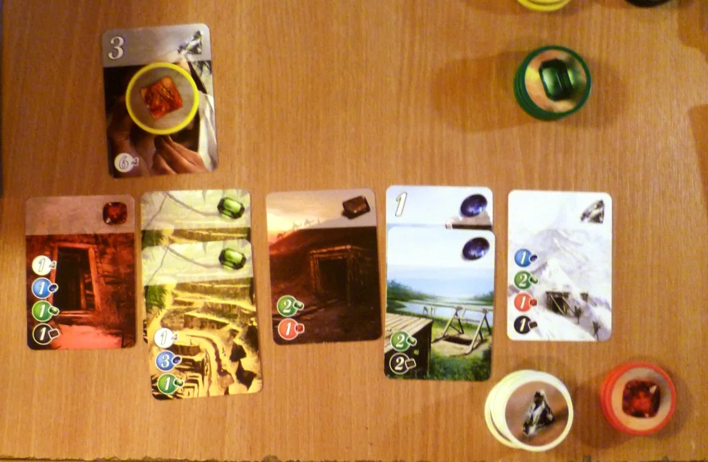 A players collection of cards in Splendor with 4 points of the 15 needed.