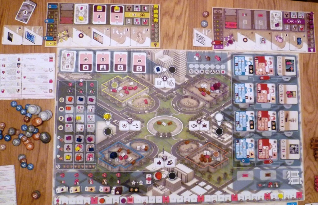 Overhead shot of the main board, the 4 main pawn positions and the associated actions are North South East and west of the central plaza, 2 of these spaces are occupied by Red (S) and Yellow (W).