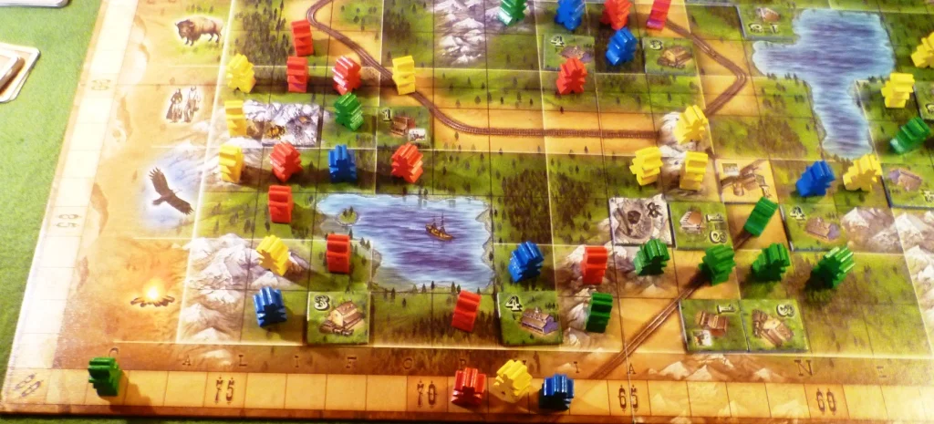 Oregon at the end won by green. The board shows groups of meeples around the buildings.