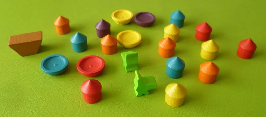 Some of the playing pieces - Huts, bowls, boat and birds