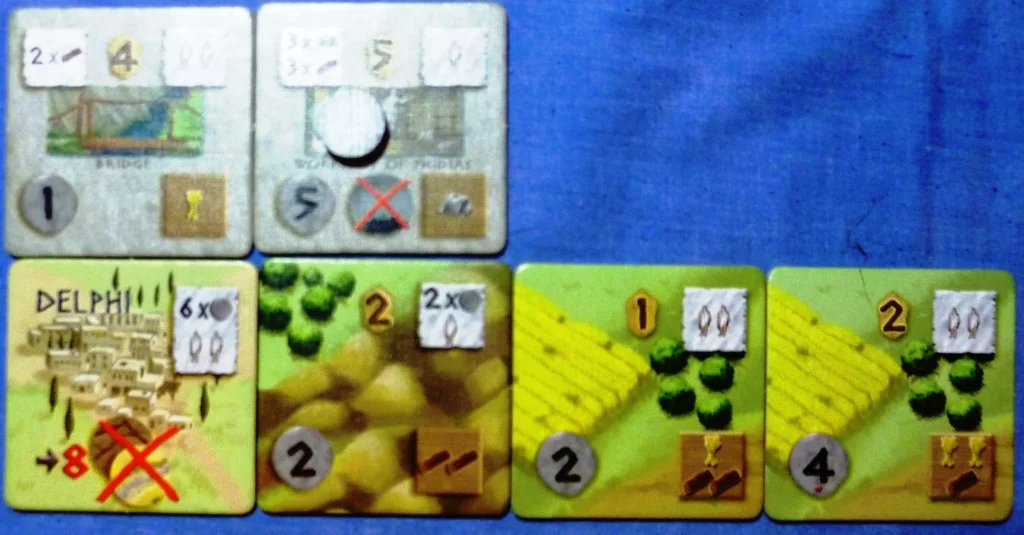 The top right town tile gave me immunity from plague (middle bottom symbol), it has a coin on it denoting I had not yet paid the 3 stone and 3 wood to build it. Note the common income symbols on adjacent land tiles.