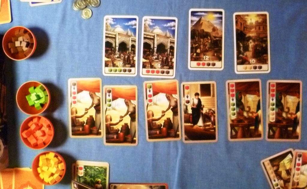 Top row is the victory point cards, bottom row is the merchant cards, all currently showing some sort of trade.