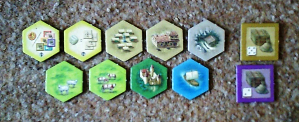 A sample of the tiles in the game with a couple of goods counters to the right