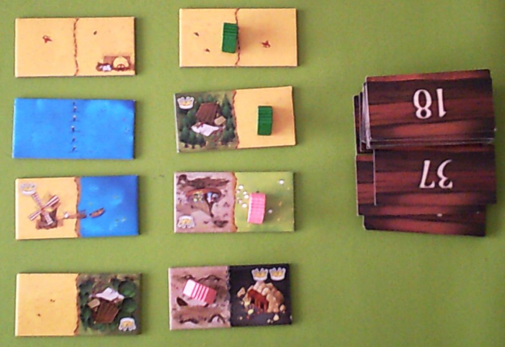 Bidding in a 2 player game (same as the 4 player except 4 different coloured pawns in 4 player) Green gets first and second choice from the new set of tiles to the left.