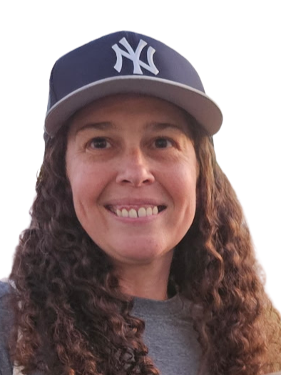Close-up of a smiling woman with dark hair pulled back against a blurred light background.