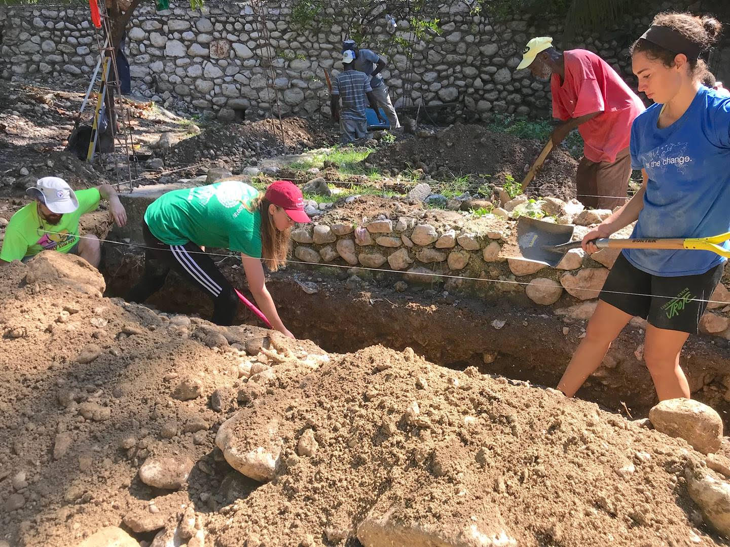 Peace youth helping to build a home in Haiti