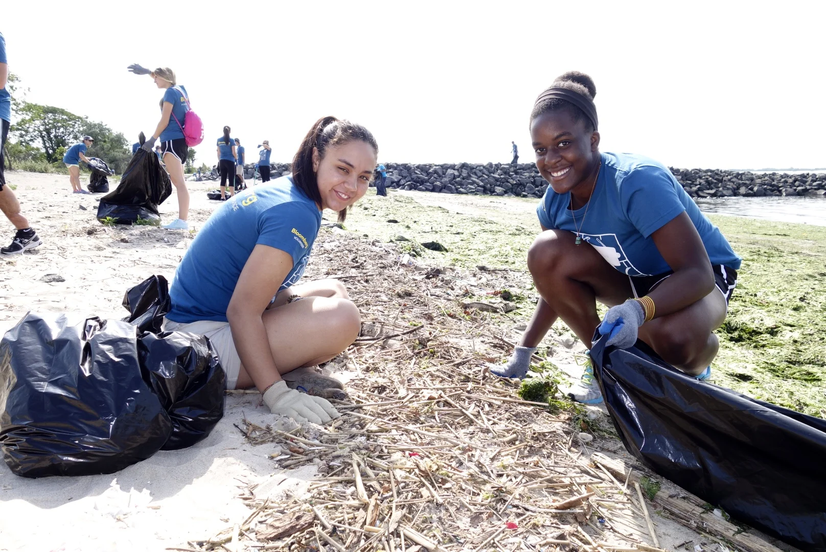 Volunteers remove debris from Plumb Beach.