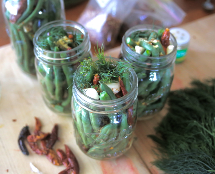 Fourth step, admire the beauty of these veggies in a jar, boil vinegar mixture to pour over jar and seal till lid pops