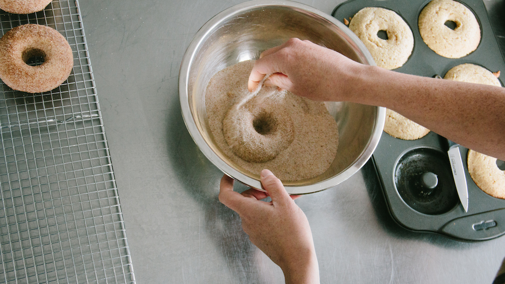 Cinnamon sugaring the Cinnamon-spice donuts .