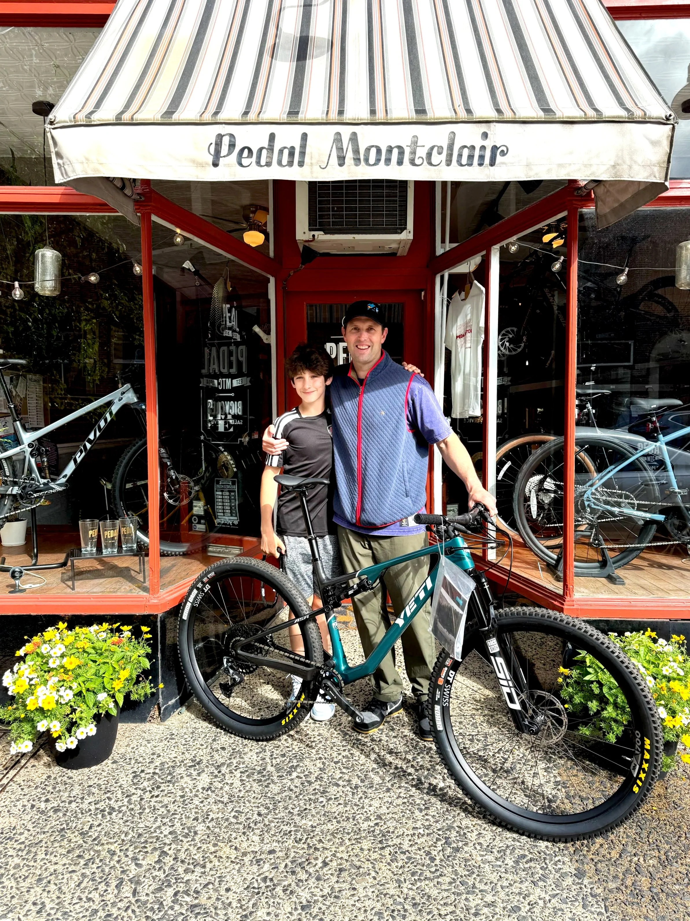 Dad and son mountain bike on Yeti cycles teal Dentist bike