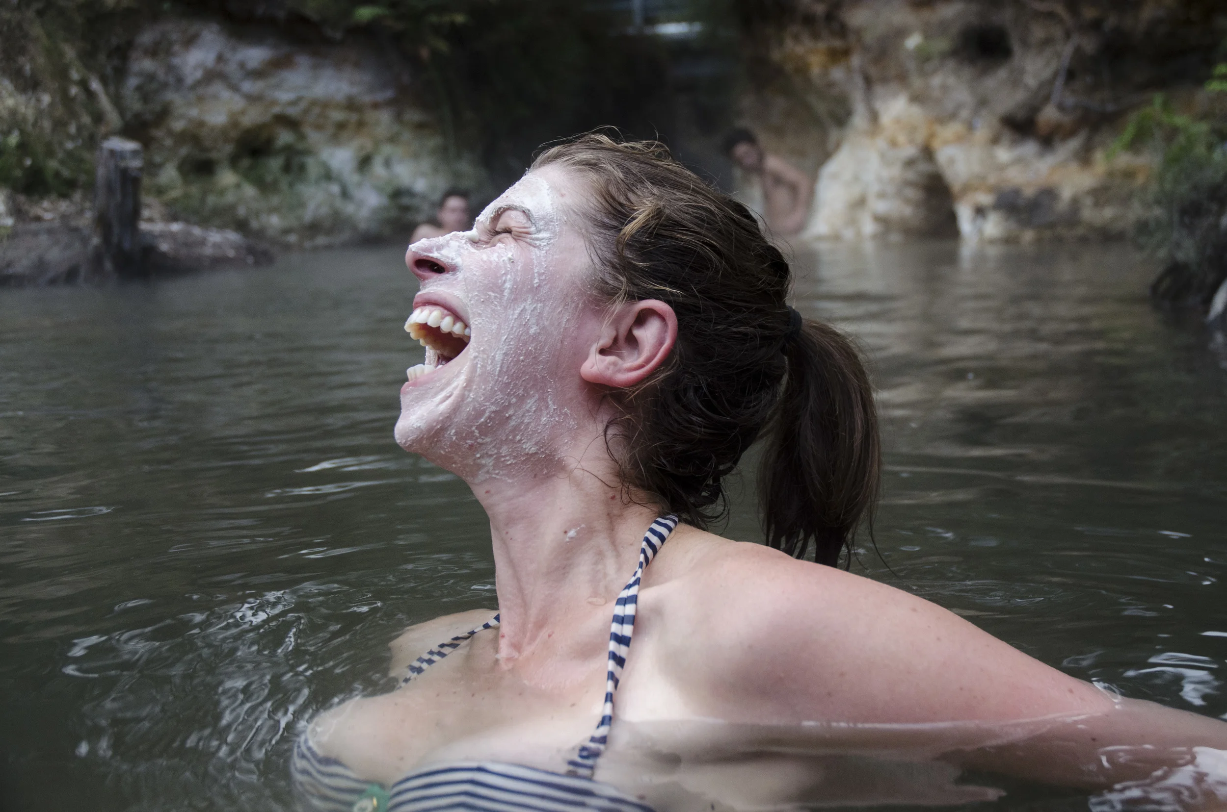 Local hotspring in Rotorua, North Island, New Zealand. Clay mask from natural deposits pictured behind. 