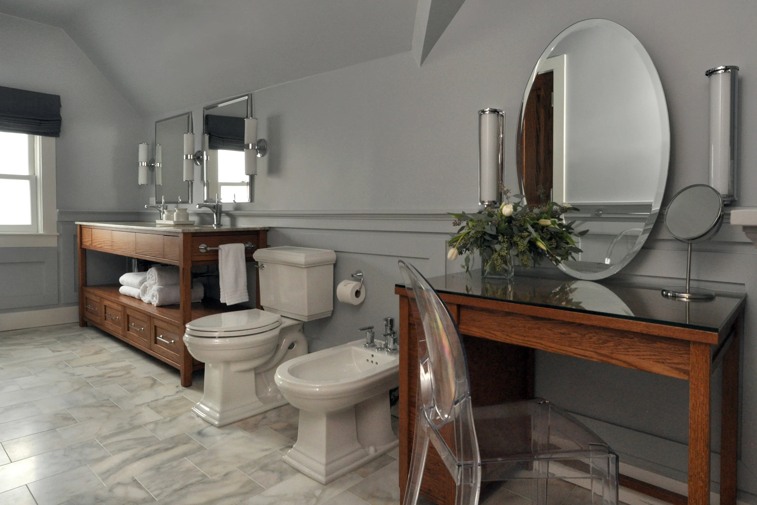 What do you do with a historic 1874 single-family home that has great bones but doesn't function properly for the active and entertaining-focused family who inhabits it? We gutted it to the studs, redesigned the layout, created a master bedroom/bathroom suite, and layered back in the historical details that kept the family in the house for over twenty years. Through thoughtful space planning, we were able to take an awkward and dark Victorian layout and transform it into a gracious and light-filled space fit for both hanging out with family and hosting large parties. This project exemplifies how good design can fundamentally transform your day-to-day living standards; the clients have never been happier in their home. What we did: Taking the baton from the original project architect after logistical challenges arose, NMI re-oriented the living spaces and bedrooms, designed a new spa-like master bath for the upper level, relocated the staircase to improve traffic flow and brought in a structural engineering team to shore up structural deficiencies in the basement. We also implemented a full space plan, selected a broad mix of contemporary, custom, and transitional furniture to compliment the client’s historic antiques (all of which were restored for the new space) and assisted the clients in curating a new contemporary art collection to juxtapose the traditional and transitional elements of the home. 