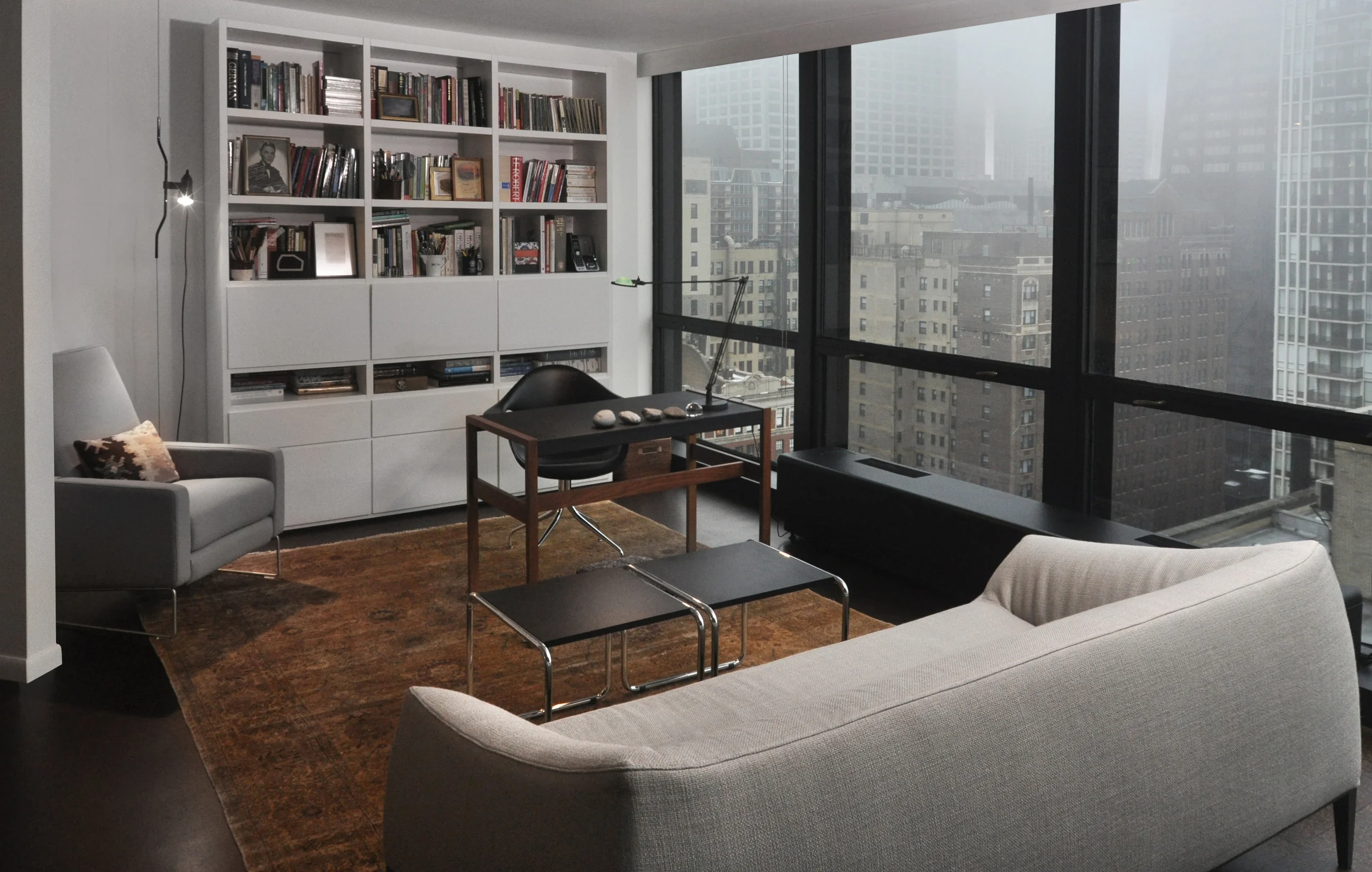 Tasked with creating a relaxing yet highly functional modern space for this client, we designed a multi-zone space plan that emphasizes the unit’s beautiful city and lake views. Add in iconic furnishings, stunningly simple Poliform bookcases, a stellar art collection, and a wealth of interesting objects and you get a highly personal living space that is timeless, elegant, peaceful, and impactful. Iconic design, redefined, just the way we like it. What we did: NMI designed a plan to seamlessly combine an adjacent unit, expand doorways, restore the original Marlo HVAC units, and incorporate new large-format cork flooring. In addition we provided the client with a comprehensive space plan that included custom designed cabinetry, furnishings, textiles, and lighting. We also aided in the curation of the client’s existing art collection.